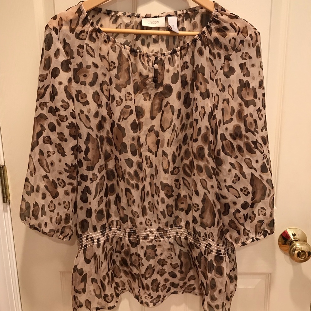 Sheer leopard print blouse with gold accents.